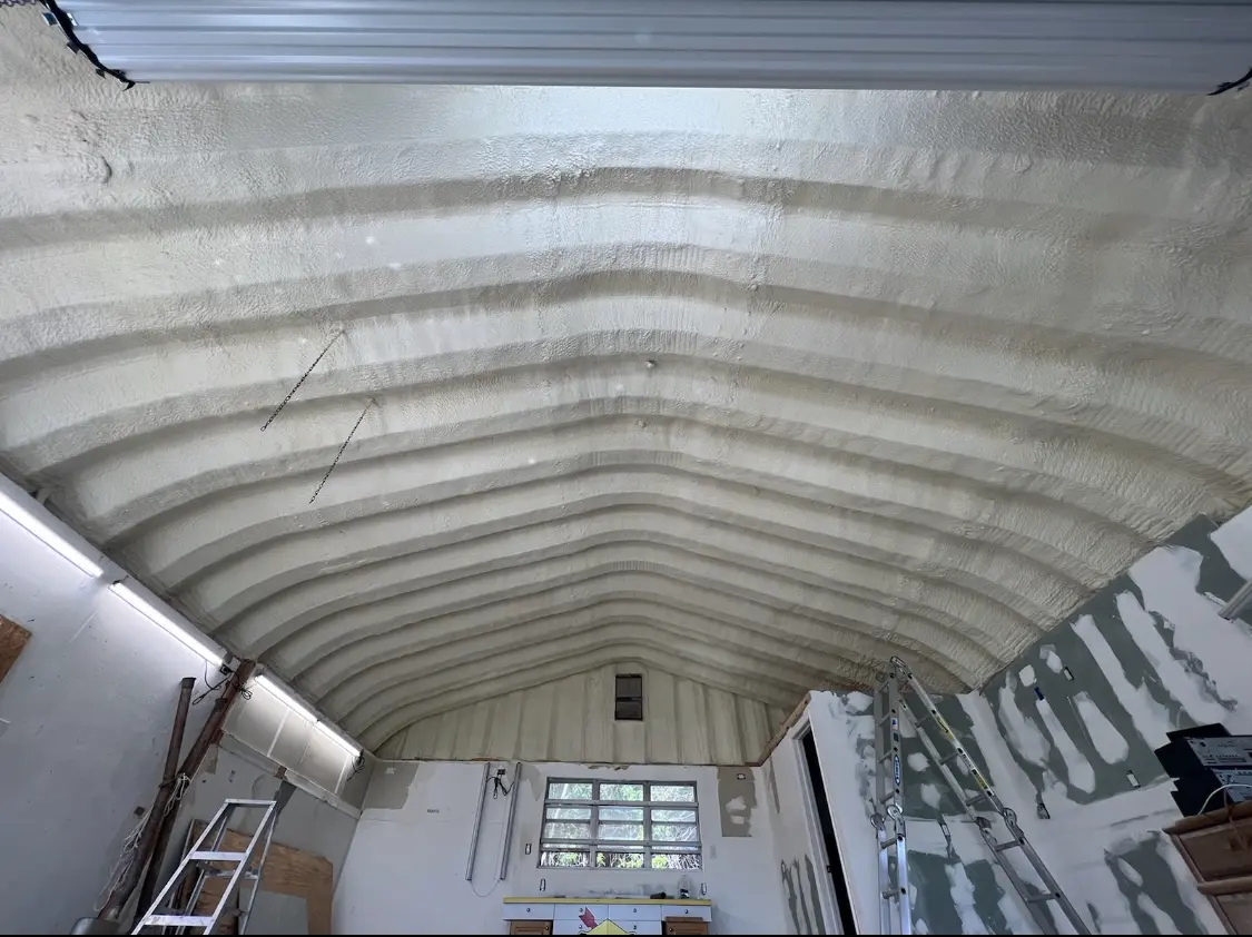 Spray polyurethane foam applied to the underside of a metal roof deck in Martic